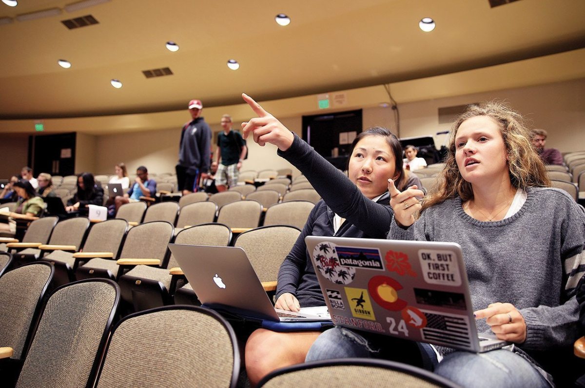 Stanford senior, Lauren Kim, left, and sophomore, Calli Ringsby, sit in a lecture hall waiting for class to begin.