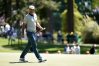 Dustin Johnson reacts on the third green during the third round of the 2016 Masters Tournament at Augusta National Golf Club.
