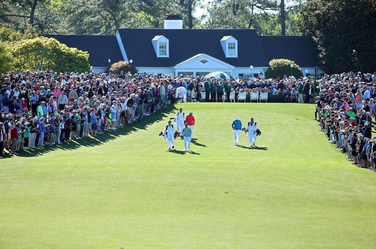Rickie Fowler, amateur Cheng Jin and Zach Johnson walk from the first tee during the first round of the 2016 Masters Tournament at Augusta National Golf Club.