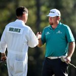 J.B. Holmes and caddie Brandon Parsons shake hands on the 18th green during the final round of the 2016 Masters Tournament at Augusta National Golf Club.