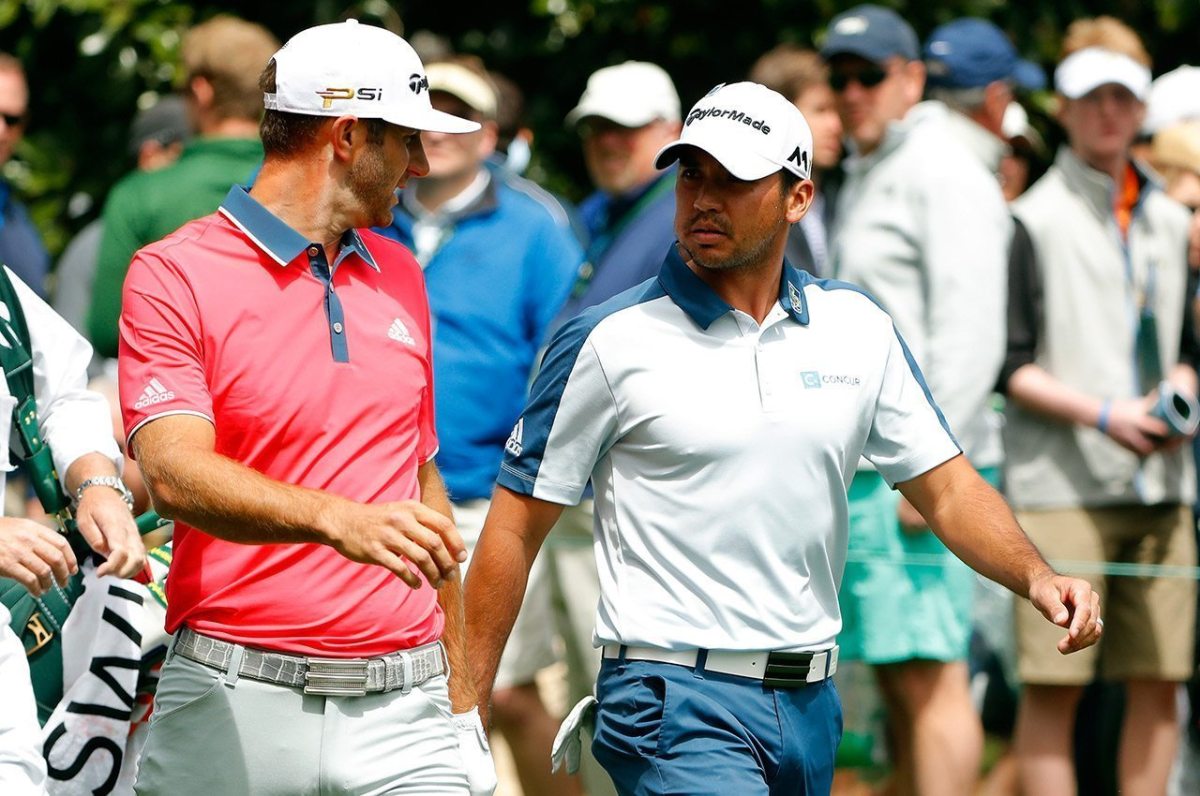 Dustin Johnson and Jason Day walk from the seocnd tee during the final round of the 2016 Masters Tournament at Augusta National Golf Club.