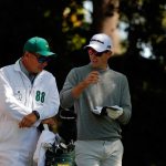 Justin Rose talks to caddie Mark Fulcher on the second tee during the first round of the 2016 Masters Tournament at Augusta National Golf Club.