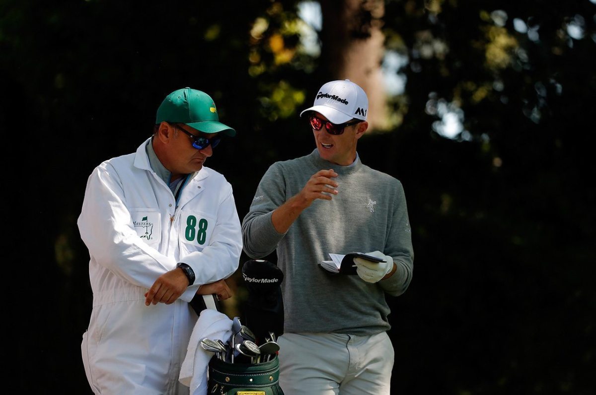 Justin Rose talks to caddie Mark Fulcher on the second tee during the first round of the 2016 Masters Tournament at Augusta National Golf Club.