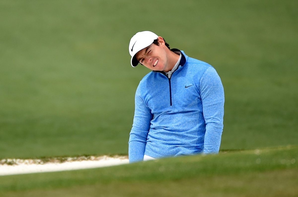 Rory McIlroy reacts to his shot from the bunker on the second hole during the final round of the 2016 Masters Tournament at Augusta National Golf Club.
