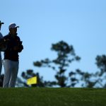 Jordan Spieth and caddie Michael Greller prepare to play his shot from the fourth tee during the first round of the 2016 Masters Tournament at Augusta National Golf Club.