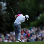 Lee Westwood plays his second shot on the fifth hole during the final round of the 2016 Masters Tournament at Augusta National Golf Club.