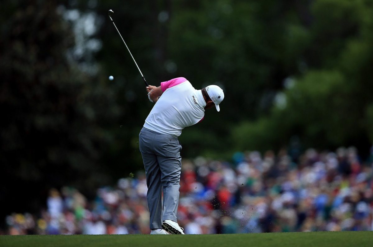 Lee Westwood plays his second shot on the fifth hole during the final round of the 2016 Masters Tournament at Augusta National Golf Club.
