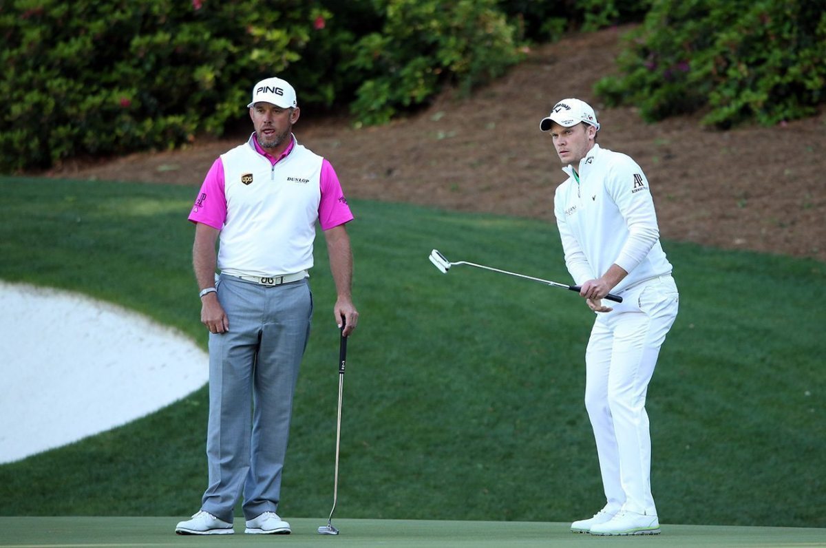 Lee Westwood and Danny Willett react on the 13th green during the final round of the 2016 Masters Tournament at Augusta National Golf Club.