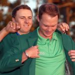 Jordan Spieth presents Danny Willett of England with the green jacket after Willett won the final round of the 2016 Masters Tournament at Augusta National Golf Club.