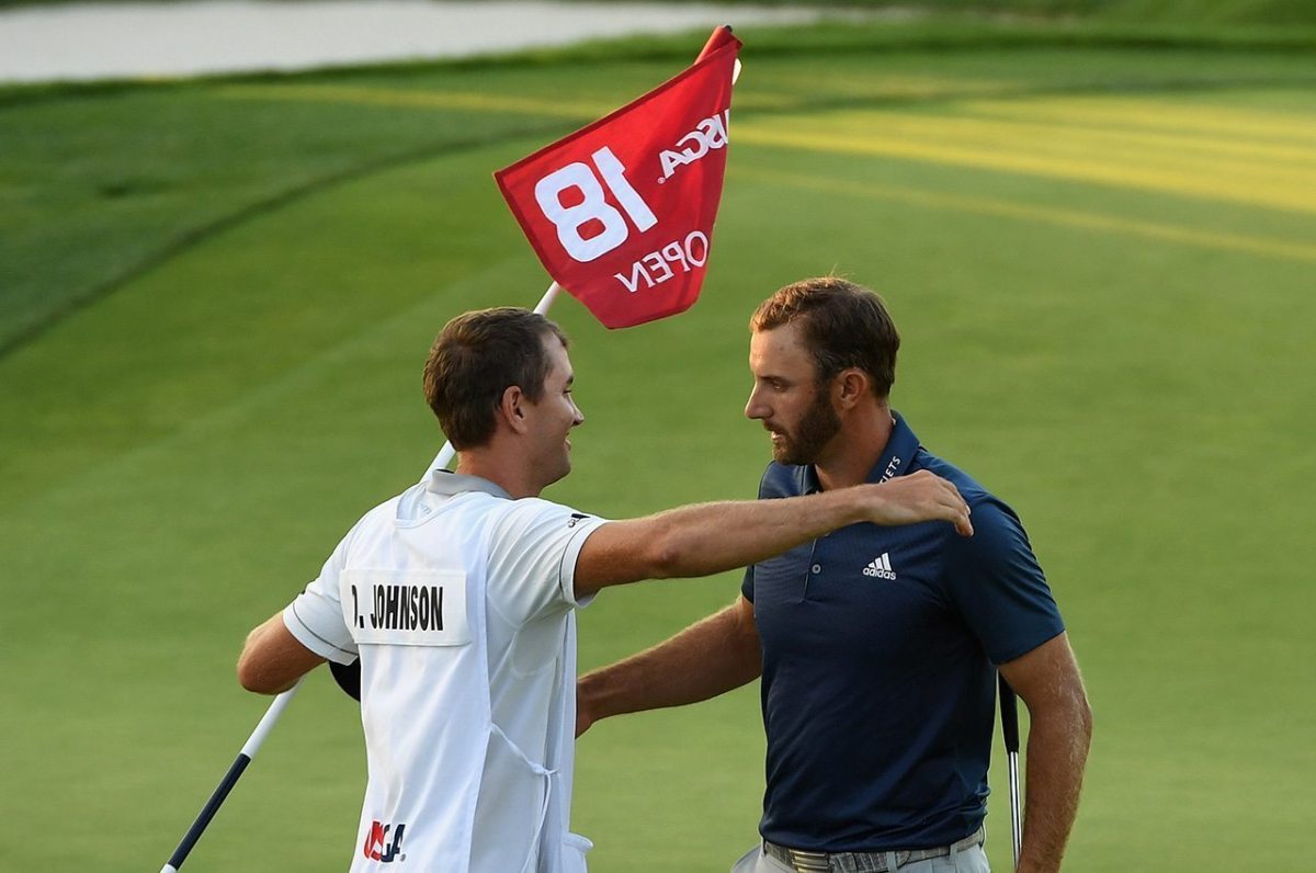 OAKMONT, PA - JUNE 19: Dustin Johnson of the United States celebrates with caddie Austin Johnson after winning the U.S. Open at Oakmont Country Club on June 19, 2016 in Oakmont, Pennsylvania. (Photo by Ross Kinnaird/Getty Images)