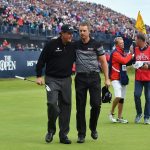 Henrik Stenson is congratulated on his victory by Phil Mickelson (left) on the 18th green during the final round of the British Open. (Getty Images)