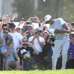 Tiger Woods plays his second shot from the rough on the 12th hole Saturday. (Sean M. Haffey/Getty Images)