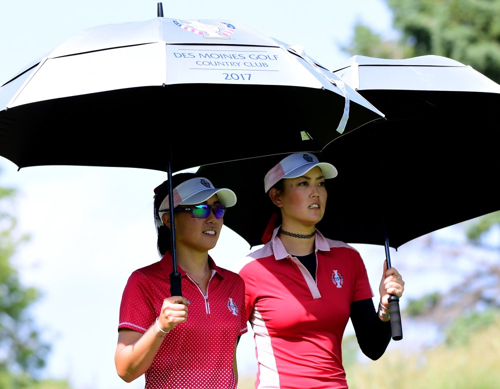 WEST DES MOINES, IA - AUGUST 18: Danielle Kang and Michelle Wie of the United States leaves the ninth tee during the afternoon four-ball matches of the Solheim Cup at the Des Moines Golf and Country Club on August 18, 2017 in West Des Moines, Iowa. (Photo by Harry How/Getty Images)