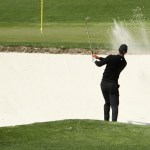 Tiger Woods plays out of the greenside bunker on the fourth hole Thursday at the 2018 Masters. (Jamie Squire/Getty Images)