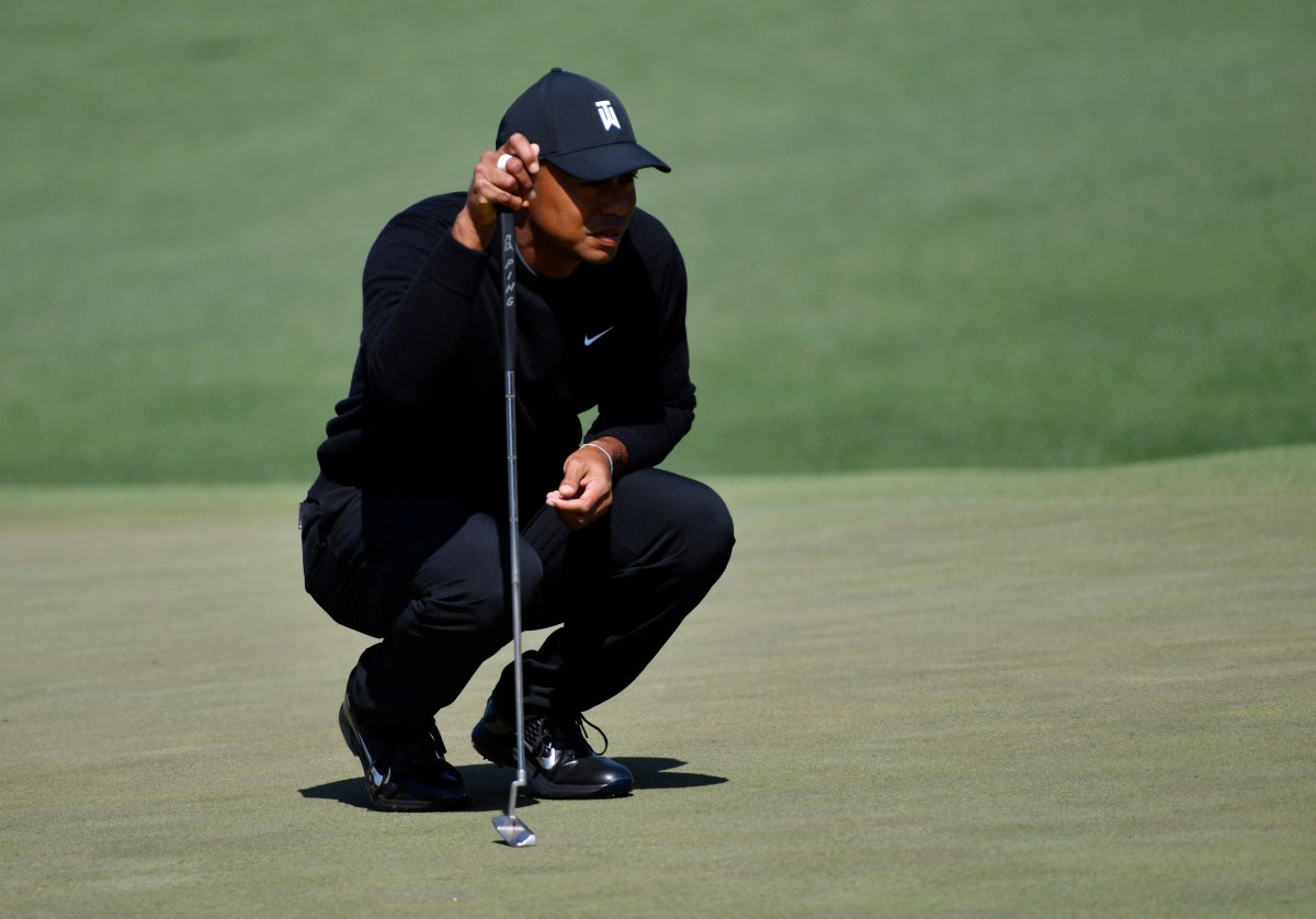 Tiger Woods lines up a putt on the 2nd green. (Michael Madrid-USA TODAY Sports)