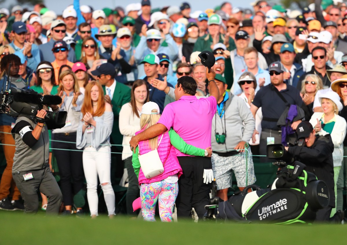 Apr 8, 2018; Augusta, GA, USA; Patrick Reed leaves the 18th green with his wife Justine after winning the Masters golf tournament at Augusta National Golf Club. Mandatory Credit: Rob Schumacher-USA TODAY Sports
