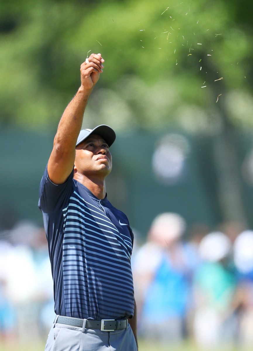 SOUTHAMPTON, NY - JUNE 14: Tiger Woods of the United States checks the breeze before playing his shot on the fourth tee during the first round of the 2018 U.S. Open at Shinnecock Hills Golf Club on June 14, 2018 in Southampton, New York. (Photo by Warren Little/Getty Images)