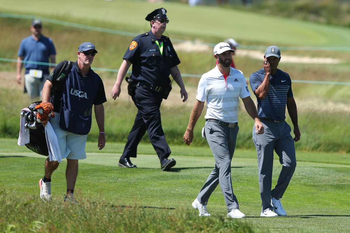 Jun 14, 2018; Southampton, NY, USA; Tiger Woods and Dustin Johnson walk up the fourth fairway during the first round of the U.S. Open golf tournament at Shinnecock Hills GC - Shinnecock Hills Golf C. Mandatory Credit: Brad Penner-USA TODAY Sports