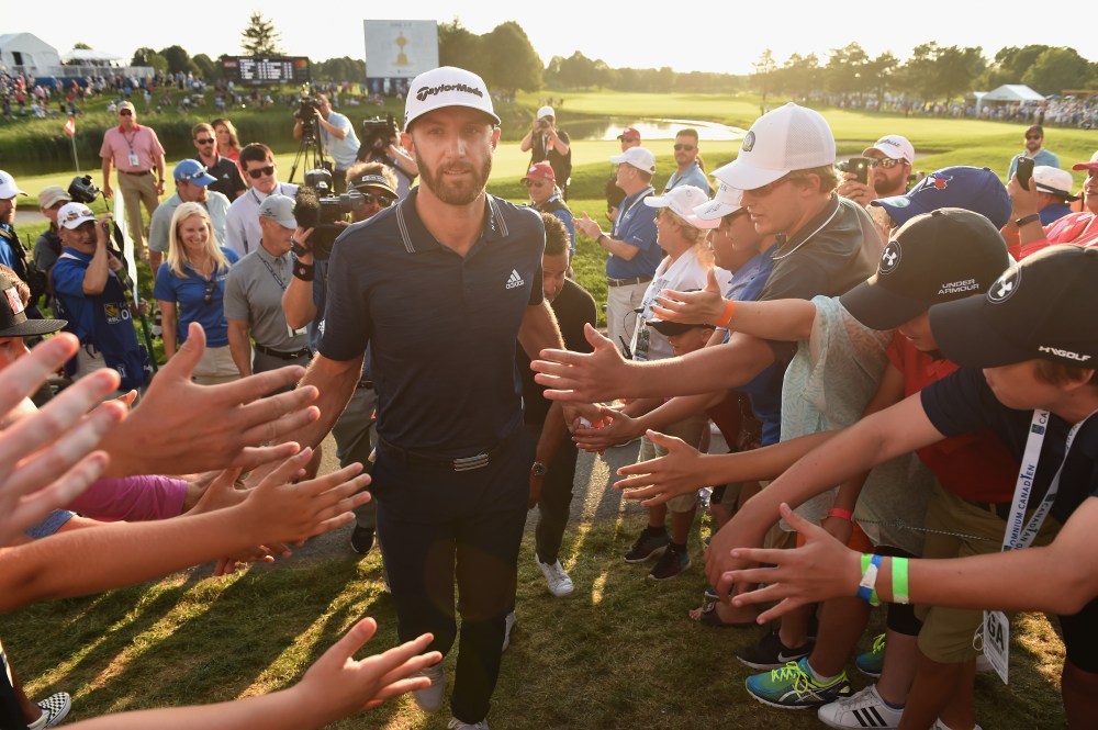 OAKVILLE, ON - JULY 29: Dustin Johnson celebrates his winning putt on the 18th hole by greeting fans Adam Scott of Australia Harris English exits the course during the final round at the RBC Canadian Open at Glen Abbey Golf Club on July 29, 2018 in Oakville, Canada. (Photo by Minas Panagiotakis/Getty Images)