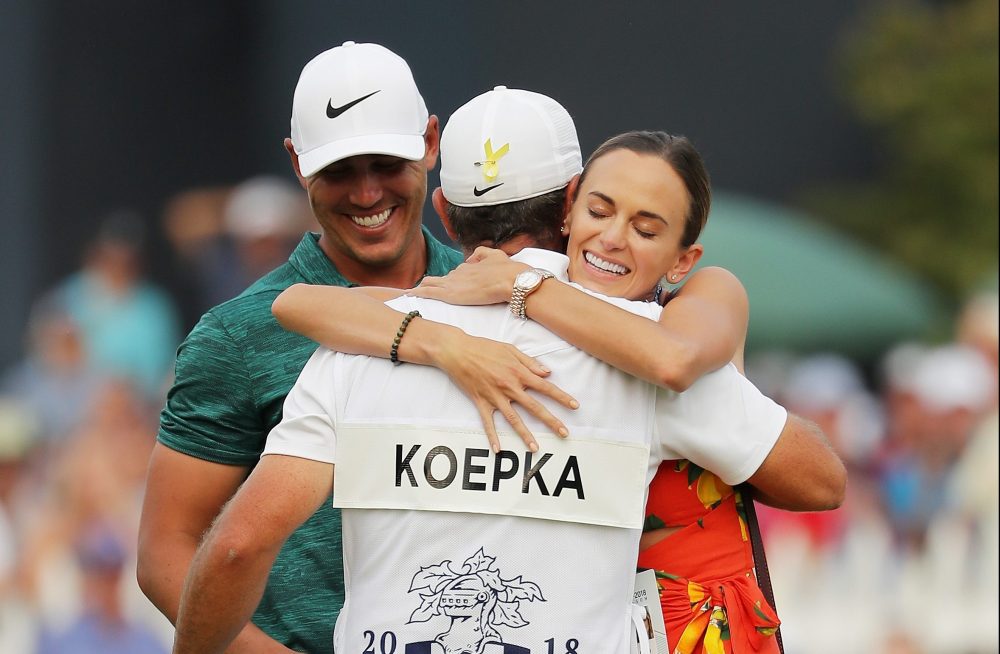 ST LOUIS, MO - AUGUST 12: Brooks Koepka of the United States celebrates with his girlfriend, Jena Sims, and caddie Ricky Elliott after winning the 2018 PGA Championship with a score of -16 at Bellerive Country Club on August 12, 2018 in St Louis, Missouri. (Photo by Richard Heathcote/Getty Images)