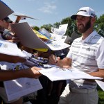 Aug 6, 2018; St. Louis, MO, USA; Dustin Johnson signs autographs off the 18th green during the Monday practice round of the PGA Championship golf tournament at Bellerive Country Club. Mandatory Credit: John David Mercer-USA TODAY Sports
