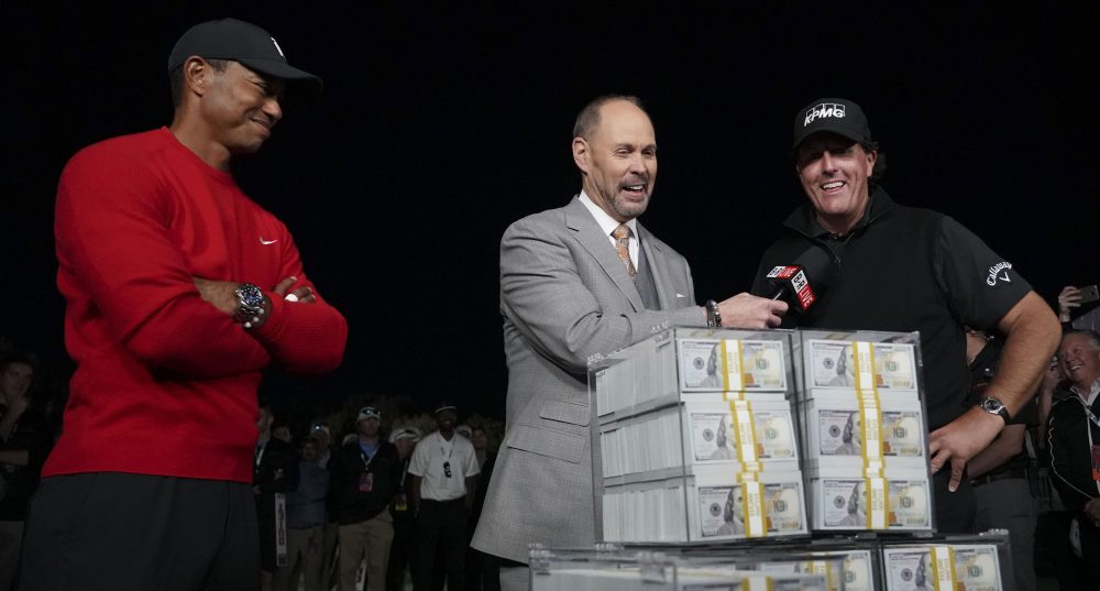 Nov 23, 2018; Las Vegas, NV, USA; Ernie Johnson (center) interviews Phil Mickelson (right) as Tiger Woods (left) looks on after The Match: Tiger vs Phil golf match at Shadow Creek Golf Course. Mandatory Credit: Kyle Terada-USA TODAY Sports