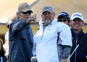 PEBBLE BEACH, CALIFORNIA - FEBRUARY 06: Actor Clint Eastwood, and comedian Daniel Lawrence Whitney react to a shot on the fist hole during the 3M Celebrity Challenge at the AT&T Pebble Beach Pro-Am on February 06, 2019 in Pebble Beach, California. (Photo by Harry How/Getty Images)