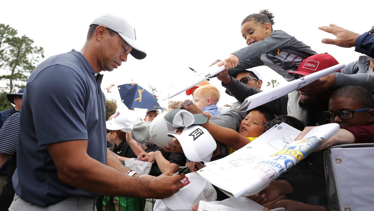 PONTE VEDRA BEACH, FLORIDA - MARCH 12: Tiger Woods signs autographs for young fans during a practice round for The PLAYERS Championship on The Stadium Course at TPC Sawgrass on March 12, 2019 in Ponte Vedra Beach, Florida. (Photo by Richard Heathcote/Getty Images)