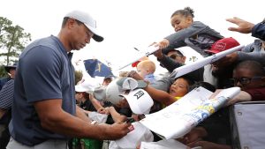 PONTE VEDRA BEACH, FLORIDA - MARCH 12: Tiger Woods signs autographs for young fans during a practice round for The PLAYERS Championship on The Stadium Course at TPC Sawgrass on March 12, 2019 in Ponte Vedra Beach, Florida. (Photo by Richard Heathcote/Getty Images)
