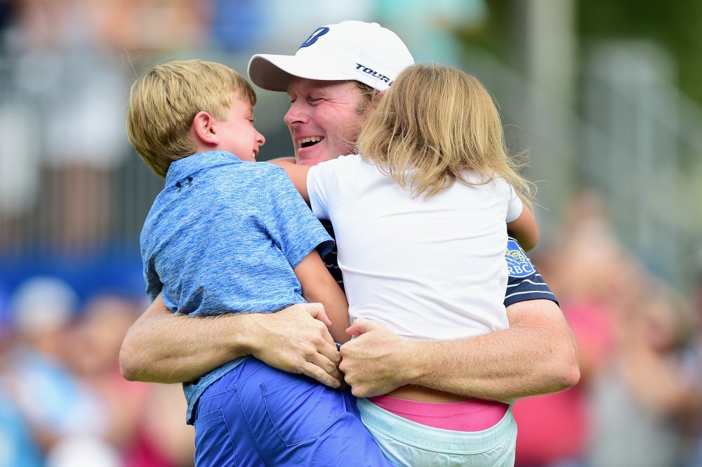 Brandt Snedeker celebrates with his children Austin and Lily on the 18th green after making his birdie putt during the final round to win the Wyndham Championship at Sedgefield Country Club on August 19, 2018 in Greensboro, North Carolina. (Photo by Jared C. Tilton/Getty Images)