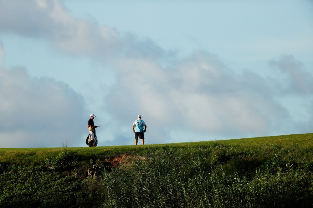 Maverick McNealy talks with his caddie during the first round of the Bermuda Championship at Port Royal Golf Course on October 29, 2020 in Southampton, Bermuda